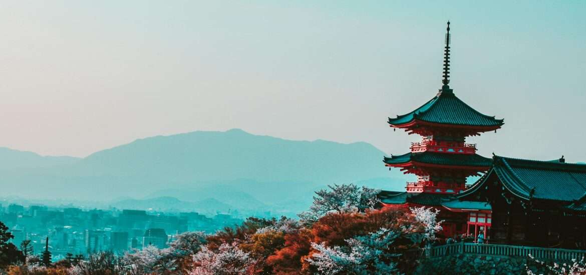 red and black temple surrounded by trees photo