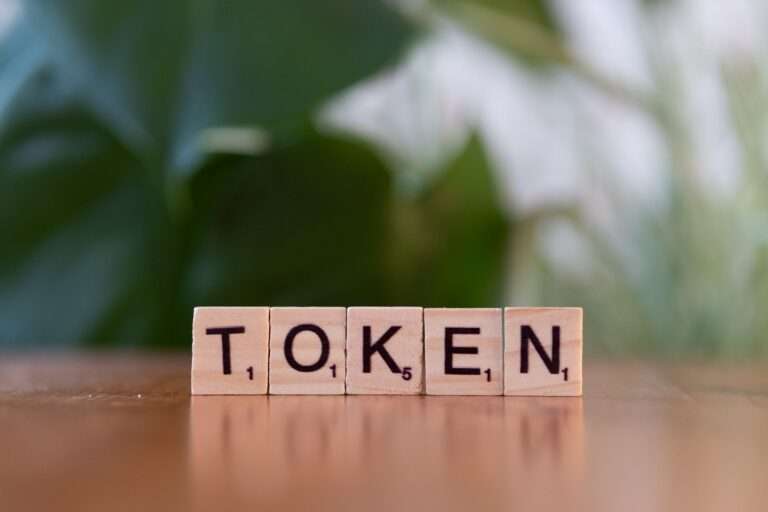 scrabble tiles spelling token on wooden surface